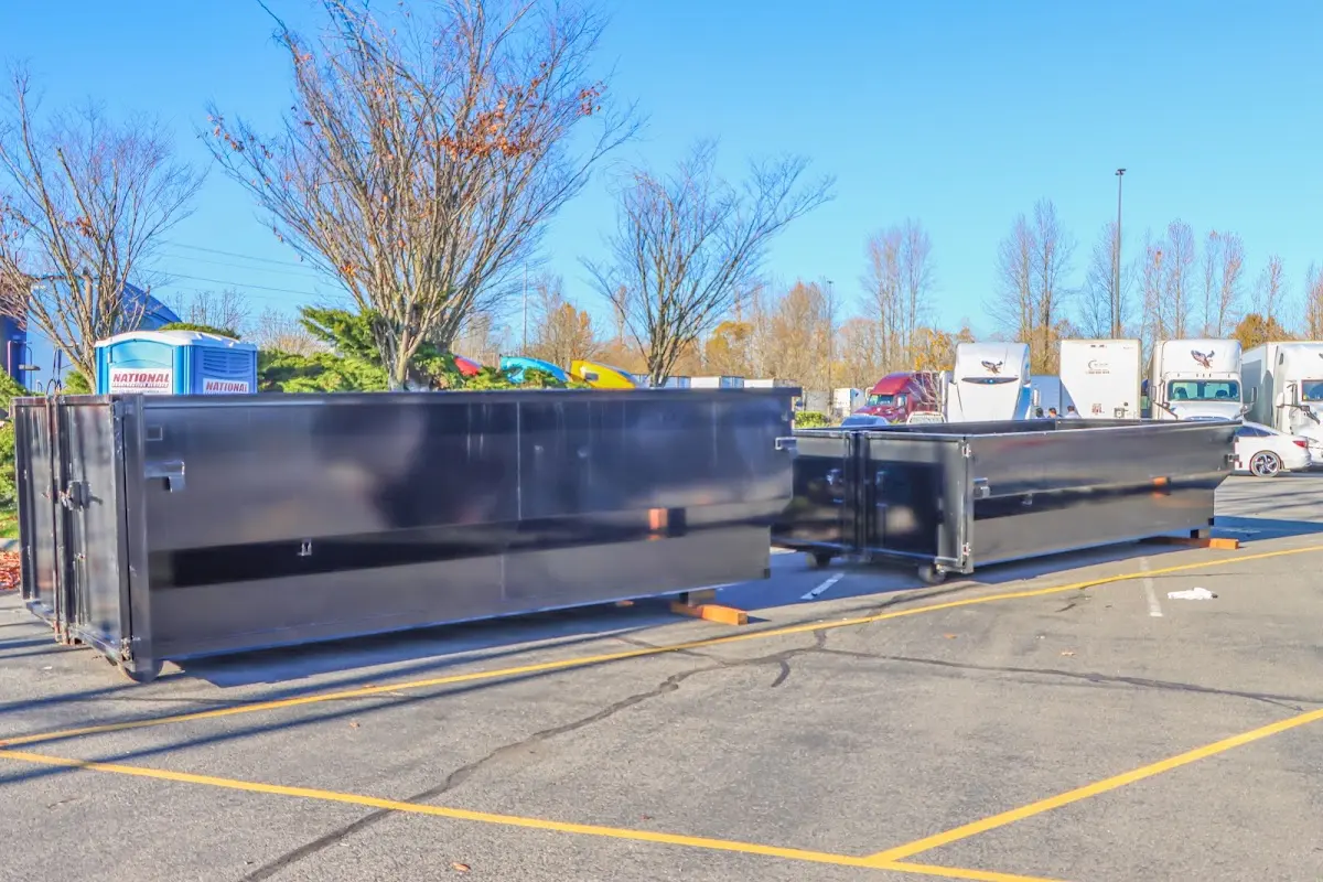 Professional dumpster rental service with roll-off container on residential driveway in Palmyra